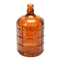 an orange glass vase is sitting on a white surface and has many small squares around it