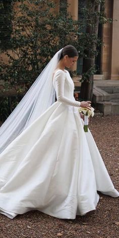 a woman in a white wedding dress and veil