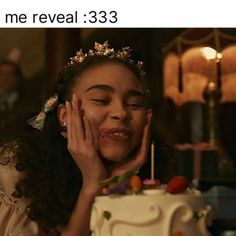 a girl with her hand on her face next to a cake that says, me reveal 33