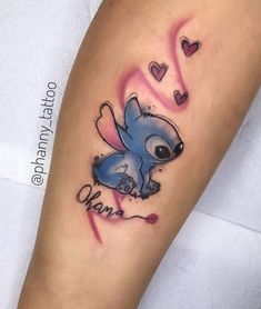 a small tattoo on the leg of a person with an elephant and hearts around it