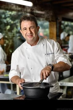 a man is cooking in a large pot