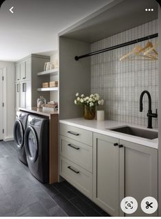 an appliance is shown in this kitchen with white cabinets and appliances, along with a washer and dryer