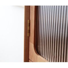 a close up of a wooden door with metal slats on the outside and inside