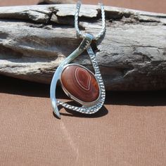 New Design! Red and White Banded Lake Superior Agate Pendant set in .950 Sterling Silver with Solid Silver Back. Total piece measures about 50 x 39mm Our reviews will tell you, If you like it here, you'll LOVE it in person! GIVE IT A TRY! If not completely satisfied with your order, contact me right away and return the item within 7 days. Instagram: www.instagram.com/agatejewelrybylarry Facebook fb.me/agatejewelrybylarry Custom work not available. Pendant chains not included. Lake Superior Agates, White Band, Lake Superior, Agate Pendant, Pendant Set, Pendant Necklaces, Jewelry Necklace Pendant, Agate, Red And White