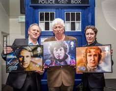 the doctor who is holding up some stamps