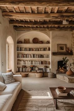 a living room filled with lots of furniture and bookshelves