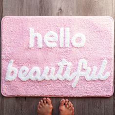 someone is standing in front of a pink door mat that says hello beautiful