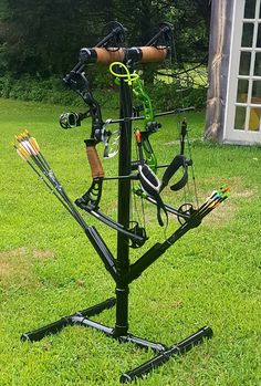 a bow and arrow stand in the grass