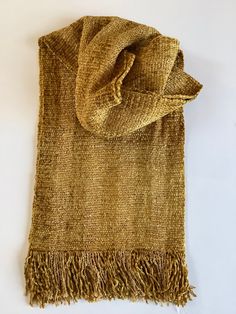 "Luxurious scarves handwoven in rich golds. The 100% rayon chenille fiber content provides rich colors, soft texture, and beautiful drape. Plus it is non-irritating to the skin. Both functional and fashionable. Hand wash, hang to dry, and steam iron. The gold scarf measures 9\" wide by 60\" long excluding fringe and the gold and yellow stripe is 7\" wide by 60\" long. The ends are secured with a tight zigzag machine stitch. I hand wash, dry, and iron all my scarves prior to shipping. Choose your Elegant Gold Scarf One Size, Gold Shawl For Fall, Bohemian Gold Shawl Scarves, Gold Scarf, Handwoven Scarf, Steam Iron, Beautiful Drapes, Yellow Stripes, Rich Colors