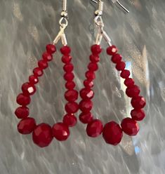 Adorn yourself with sophistication and grace with these exquisite dangly red teardrop earrings, crafted with glass beads that catch the light with every movement. These earrings are a harmonious fusion of classic design and contemporary elegance, creating a captivating accessory that is sure to turn heads. Elegant Handmade Red Earrings, Elegant Red Heart Beads Earrings, Red Colorful Beaded Dangle Earrings, Vibrant Red Beaded Earrings, Red Beaded Drop Earrings, Pierced, Unique Beaded Jewelry, Antique Gold Earrings, Bat Earrings, San Ramon