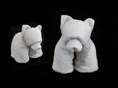 two white towels folded in the shape of animals, one with its mouth open and another with it's eyes closed