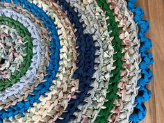 a close up of a rug on the floor with different colors and shapes in it