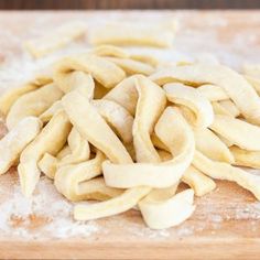 homemade egg noodles on a cutting board with text overlay that reads homemade egg noodles