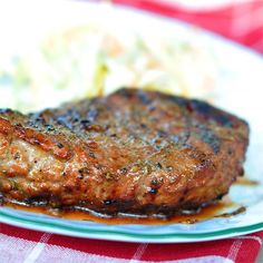 a piece of steak on a plate with gravy