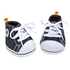 a pair of black and white shoes with yellow laces