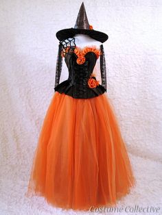 an orange and black dress with a witch hat on top