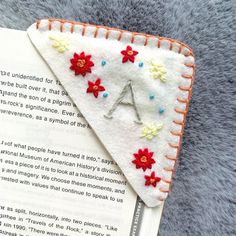 a close up of a bookmark with flowers on it