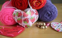 several balls of yarn and hearts on a table