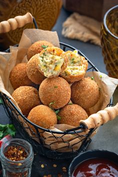 a basket full of food sitting on top of a table next to some dipping sauce