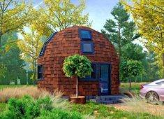 a car is parked in front of a round house