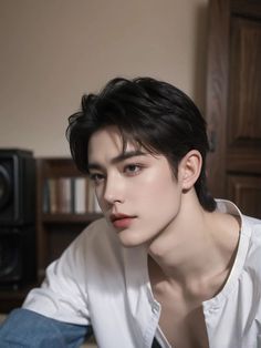 a young man with black hair and white shirt