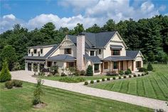 an aerial view of a large house in the middle of a lush green field with lots of trees