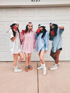 four young women standing in front of a garage door