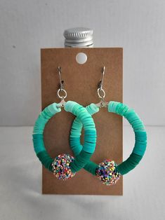 two green hoop earrings with sprinkles and beads on each earring hook