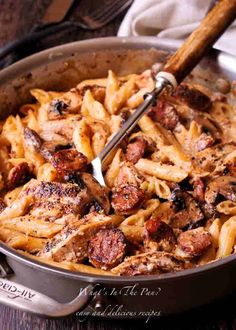 a skillet filled with pasta and meat