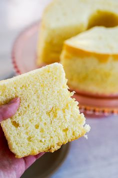 a person holding a piece of cake in their hand