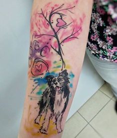 a dog is shown on the arm and it's watercolor paint splattered