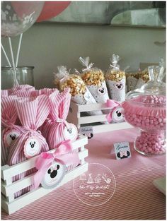 pink and white candy bar with minnie mouse bags, popcorn balls, and other treats