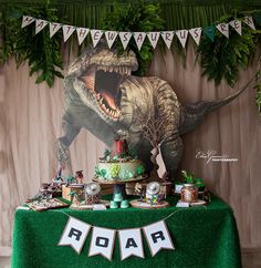 a dinosaur themed birthday party with cake and decorations