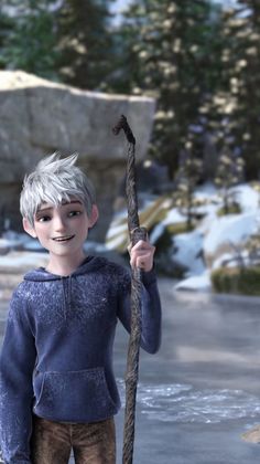 a young boy is holding a stick in the snow