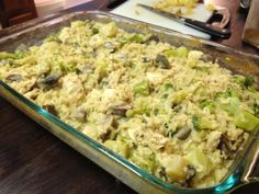 a casserole dish with broccoli and mushrooms in it on a table