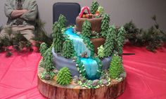 there is a cake that looks like a waterfall in the middle of a tree stump