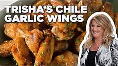 a woman standing in front of a bowl filled with food and the words trisha's chile garlic wings