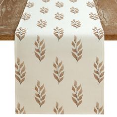 a table runner with brown leaves on it