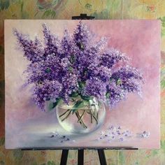 a painting of purple flowers in a glass vase on a easel with pink background