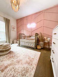 a baby's room with a crib, dresser and bed in the corner