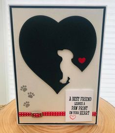 a card with a silhouette of a woman holding a dog's paw and the words best friend leaves a paw print on your heart