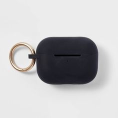 an apple airpods case with a gold ring