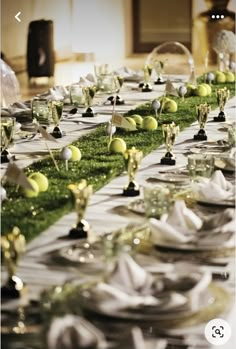 a long table is set with plates and silverware for an elegant dinnereon party