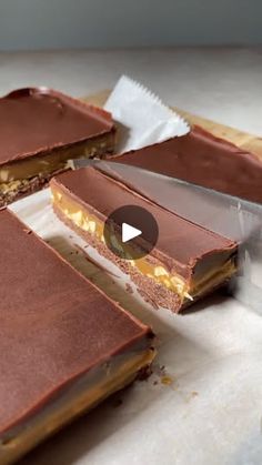 87K views · 391 reactions | Vegan Double Chocolate Peanut Butter Caramel Bars | make these healthy homemade Snickers for Halloween!! vegan + GF 🙌 ambitiouskitchen.com/vegan-chocolate-peanut-butter-caramel-bars | By Ambitious Kitchen | Dessert recipes are often
inspired by things I enjoyed as a kid and one of those was
Snickers bars. So today I am recreating a Snickers bar but
making a chocolate bottom because who the Hell doesn't
love that. I mean it tastes like a brownie. Then we've got
that creamy caramelly nougat center. I don't know. Some
peanuts. It's looking really good you guys. And then finally
stick that in the freezer. Pour some dark chocolate on top and
there you go. Did I mention that these are vegan and gluten
free? Anyway, I think you should really make them. Find the
recipe