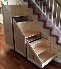 an open cabinet under the stairs in a house