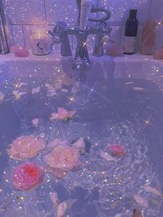 pink roses floating in a bathtub filled with soapy water and sparkling lights on the walls