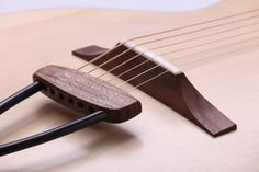 a close up of an acoustic guitar with strings