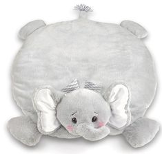 an elephant stuffed animal laying down on top of a pillow with its head tucked under it's back