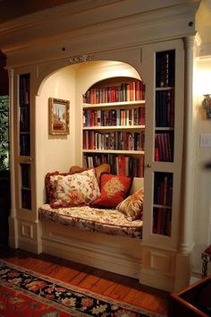 a living room filled with lots of books and furniture