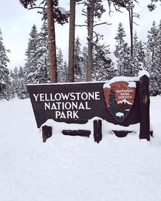 the yellowstone national park sign is covered in snow